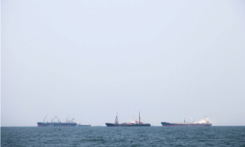 three ships in ocean
