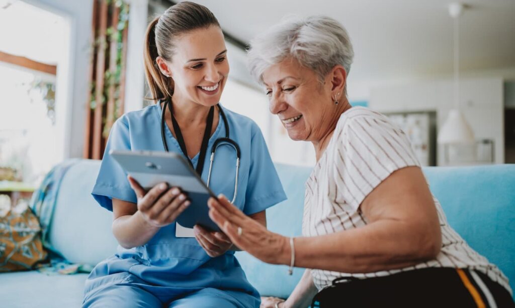 Healthcare professional sharing medical information with a patient using a tablet.