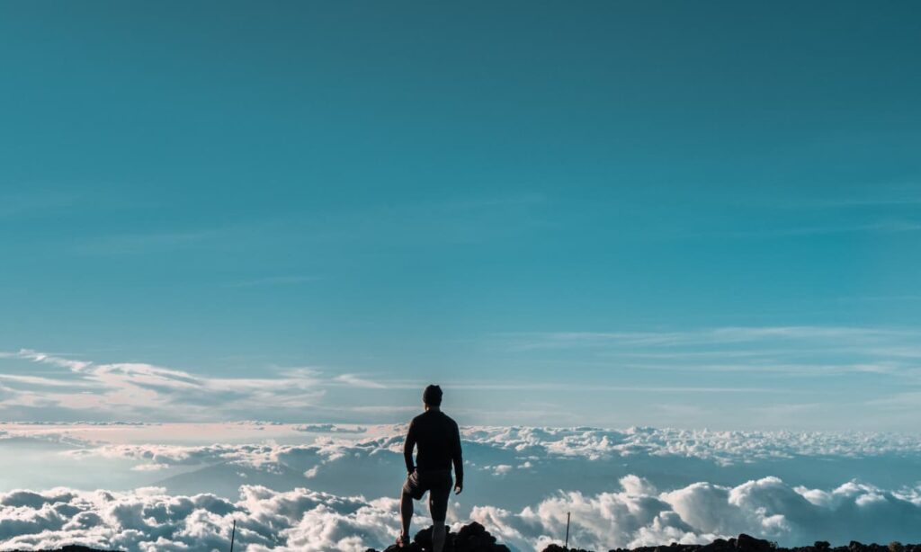 Man standing adjacent to clouds