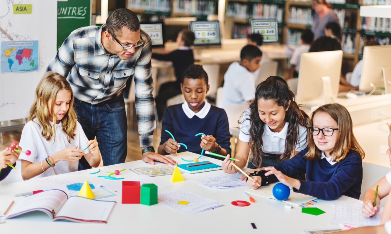 Teacher delivers a lesson to young students.