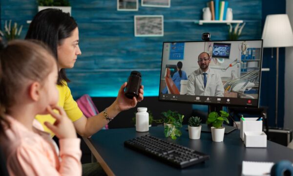 Mother and daughter virtually consulting a doctor.