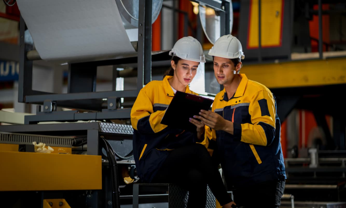 Two engineers at a manufacturing plant.