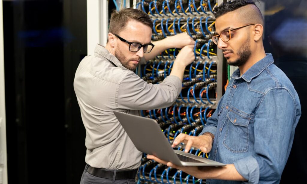 Managed Services vs. In-House IT concept photo: IT professionals conducting proactive server maintenance.